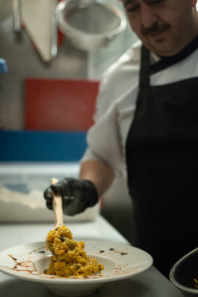istock Chef serving a plate in in the kitchen 1418841682