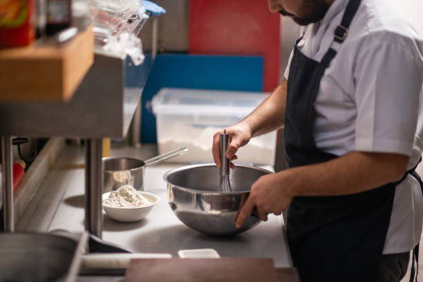 istock Male chef preparing a pizza in the kitchen 1418841854