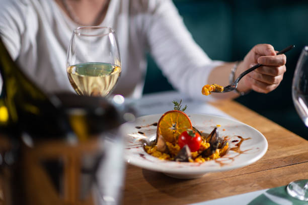 istock A woman eating seafood risotto 1418842167