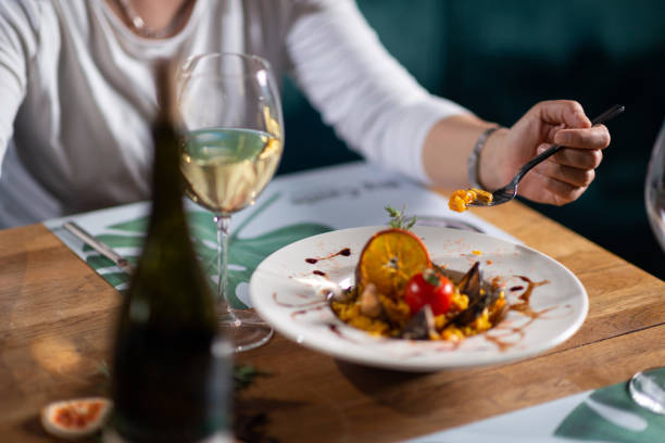 istock A woman eating seafood risotto 1418842180