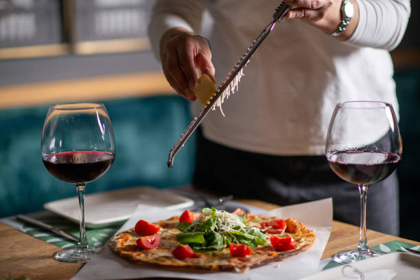 a chef hands grating cheese on a pizza - recipe ingredient grater cheese grater imagens e fotografias de stock