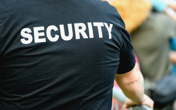 Rear view of security staff Rear view of security staff at a public event, copy space bouncer security staff stock pictures, royalty-free photos & images