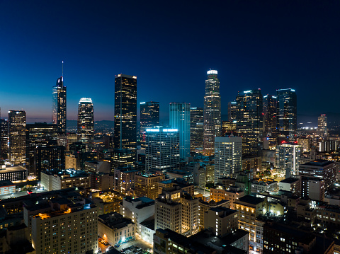 Aerial view of Downtown Los Angeles at night, looking towards the skyscrapers of the financial district from over the Historic Core.