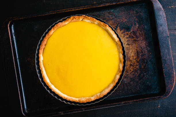 baked lemon curd tart viewed from above - tart dessert tray bakery imagens e fotografias de stock