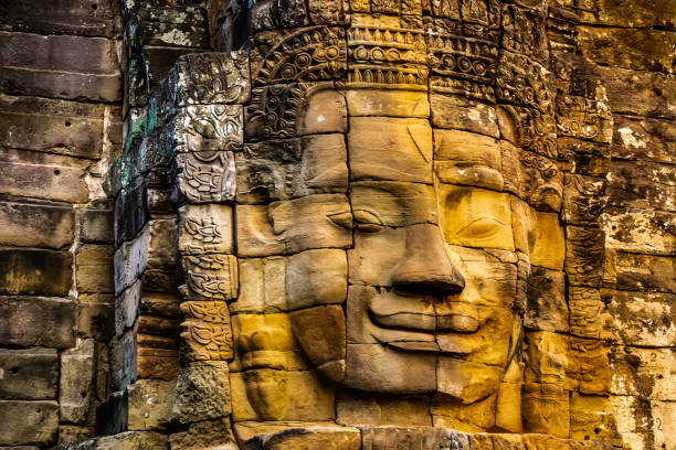 amazing stone murals and statue bayon temple angkor thom. ancient khmer architecture. location: siem reap, cambodia. artistic picture. beauty world. - wat angkor thom imagens e fotografias de stock