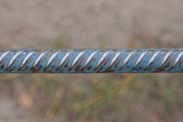 one long iron gray blue bar rebar in the street