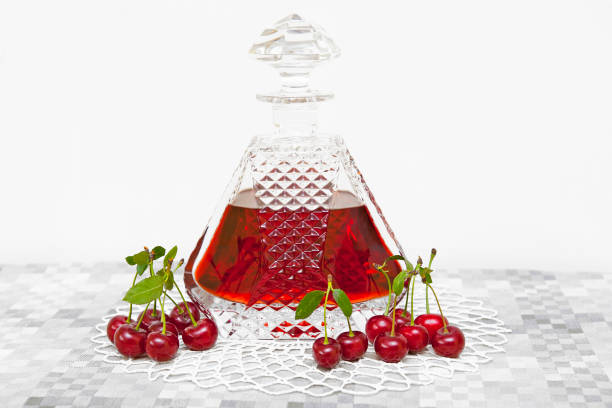 cherry alcohol in crystal carafe - decanter crystal carafe glass imagens e fotografias de stock