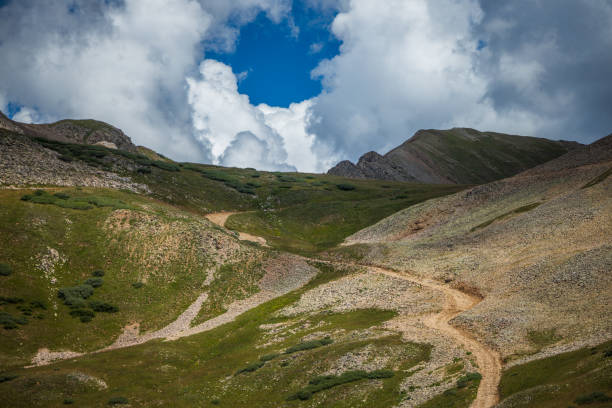 istock Road to the mountains summit with dramatic lighting 1418848942