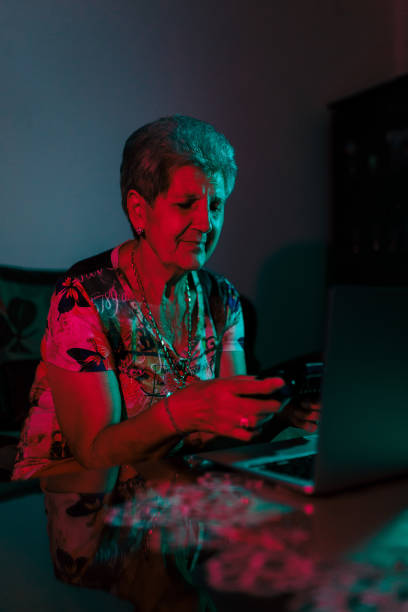 istock Grandma is Playing Video Games on Laptop 1418851764