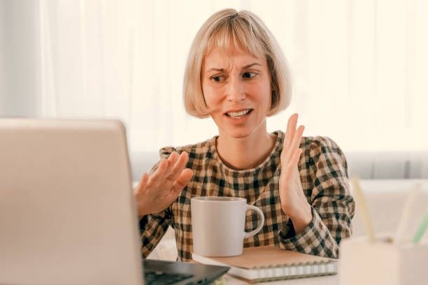 istock Business Woman listening educational lecture on computer, watching webinar, studying on online courses, writing notes in paper copybook, e-learning concept 1418852400