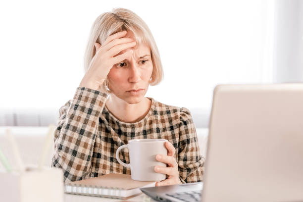 istock Business Woman listening educational lecture on computer, watching webinar, studying on online courses, writing notes in paper copybook, e-learning concept 1418852728