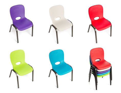 Collection of plastic chairs for children of diverse colors on a white background.