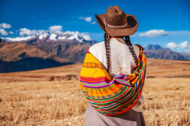 Peruvian woman in national clothing looking at Andes, The Sacred Valley Peruvian woman in national clothing admiring view of Andes in The Sacred Valley. The Sacred Valley of the Incas or Urubamba Valley is a valley in the Andes  of Peru, close to the Inca  capital of Cusco and below the ancient sacred city of Machu Picchu. cusco province stock pictures, royalty-free photos & images