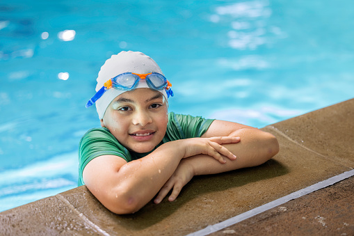 High quality stock photos of a 11-year-old mixed race swimmer at the pool posing for some portraits.