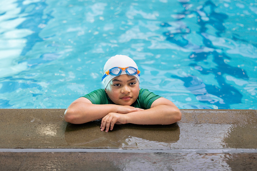 High quality stock photos of a 11-year-old mixed race swimmer at the pool posing for some portraits.