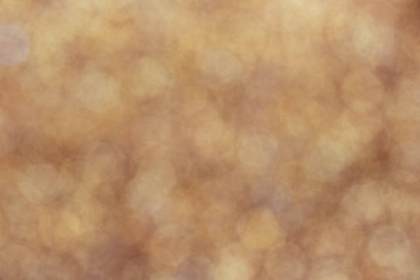 istock Gold light shiny bokeh abstract blur background with bright round defocus golden pattern 1418879085