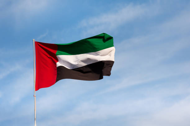 istock UAE flag waving in the sky, national symbol of UAE 1418879110