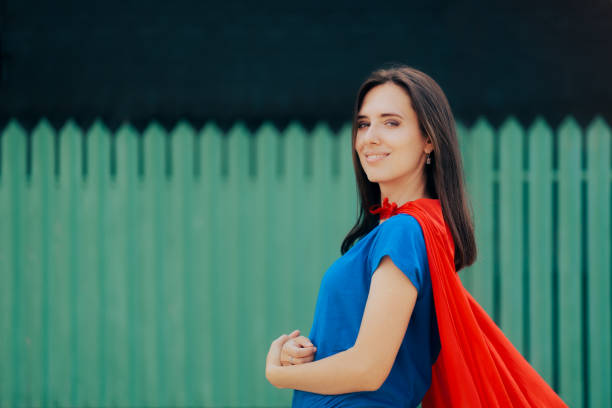 A woman dressed as a superhero flexing her muscles and screaming out loud.
