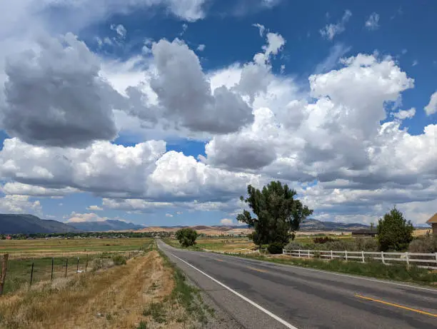 Country road and monsoon clouds near Ephraim Utah in beautiful farmland