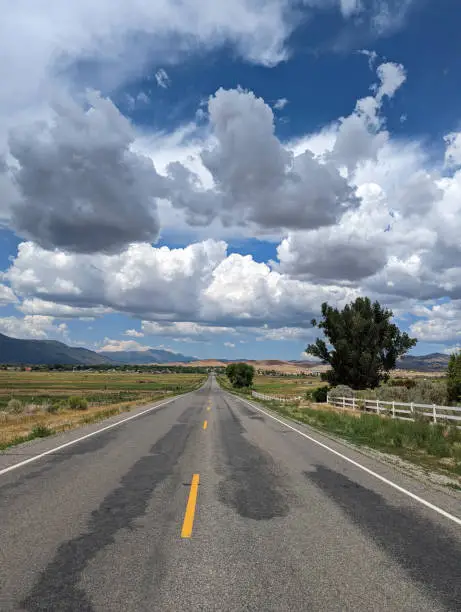 Country road and monsoon clouds near Ephraim Utah in beautiful farmland