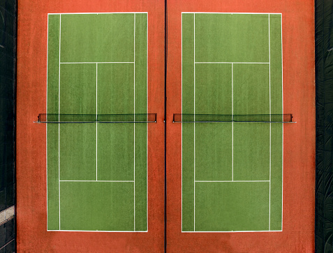 Overhead aerial view of a synthetic tennis court