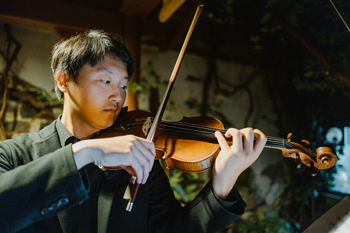 Asian Violinist Playing on Outdoor Stage