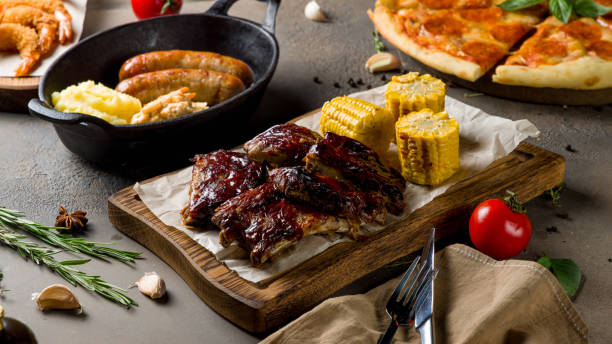 istock Barbecue pork ribs with corn on the board on brown concrete table 1418901244