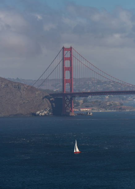 Sailboat heading out to sea under the Golden Gate Bridge