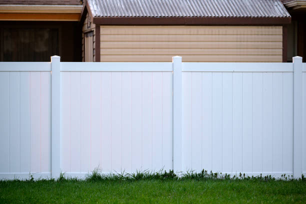 White plastic fence for back yard protection and privacy White plastic fence for back yard protection and privacy. white vinyl fence stock pictures, royalty-free photos & images