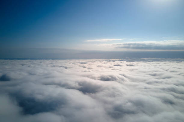 istock Aerial view from high altitude of earth covered with puffy rainy clouds forming before rainstorm 1418910536