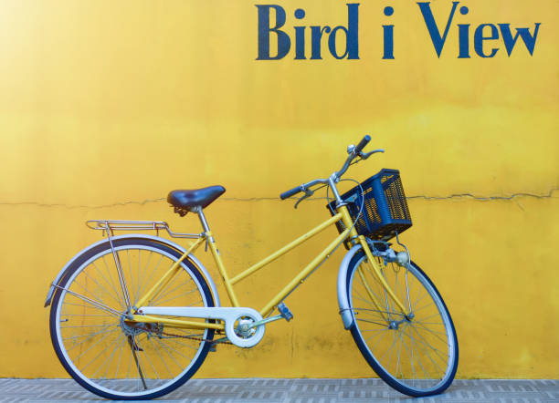 istock Bicycle travel idea and yellow wall 1418910786