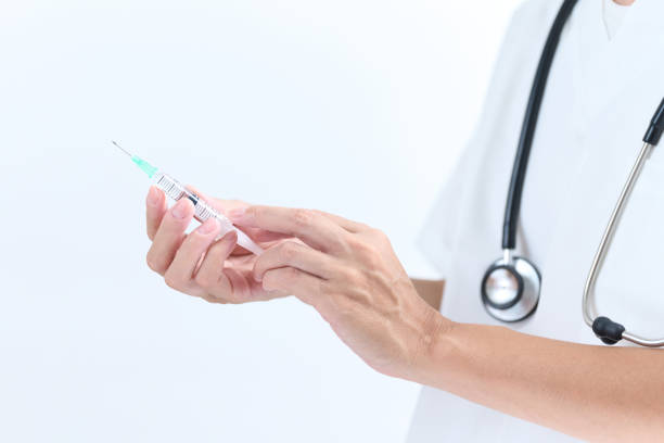 Asian doctor hand with syringe