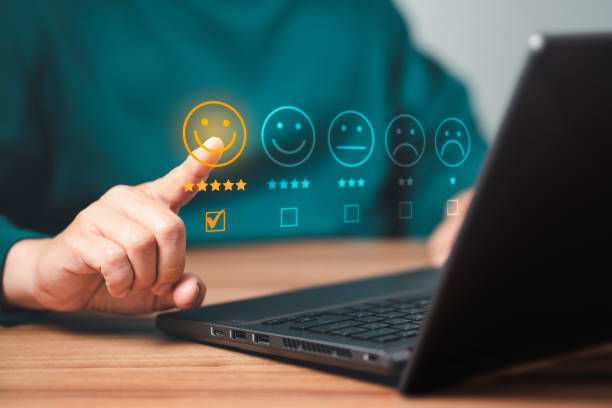 istock Man using a laptop in give rating to service experience on application. Online customer review satisfaction feedback survey. 1418913474