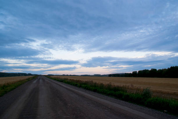 istock Cloudy blue dawn over a wheat mown field. 1418916444