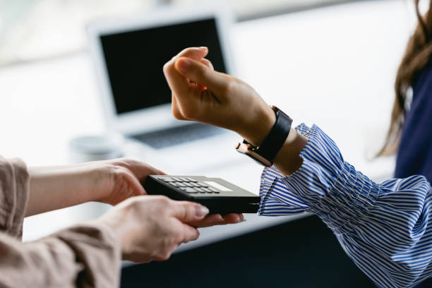 istock Woman's hand (body parts) that makes a smart watch payment 1418919877