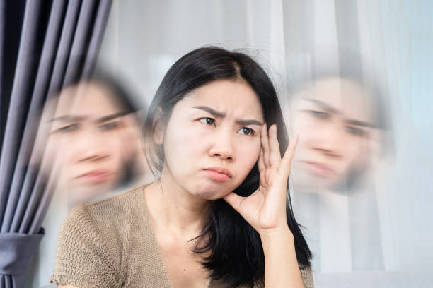 istock Asian woman suffering from dizziness hand holding her headache 1418922009