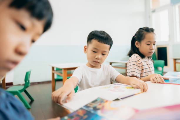 istock Elementary school students reading storybooks in classroom 1418923304