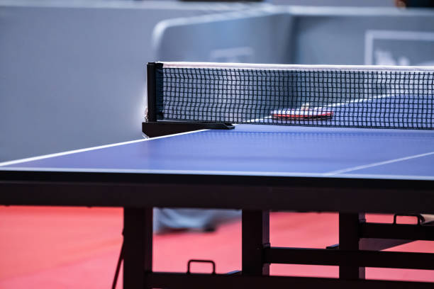 istock Blue and smooth surface table tennis table with tight black net to being prepared for practice and competition. 1418924559