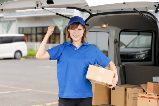 A woman loading a light freight vehicle. Energetic and active personality. Image of a transportation and moving company. stock photo