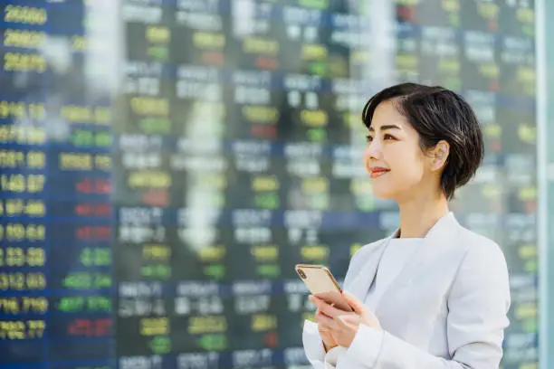 woman looking at stock market board