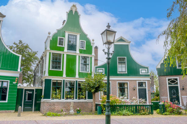 Colorful and unconventional modern and traditional architecture of  Dutch houses stacked atop each other in Zaandam, Netherlands. These fairytale-like modern architectural buildings feature whimsical motifs, showcasing the unique and playful Dutch architectural style.