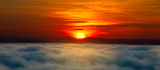 istock Panorama fog with vivid orange sunrise  sky clouds background 1418928326