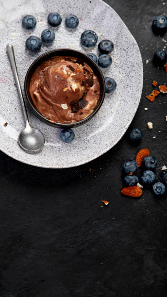 istock Chocolate ice cream with berries on dark background 1418931545