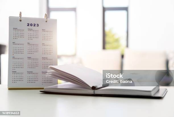 2023 Calendar And Note Pad On The Desk Stock Photo - Download Image Now - Calendar, 2023, Desk