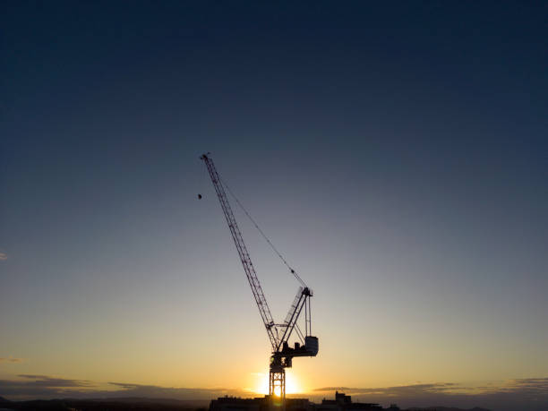 istock Silhouette of tower crane 1418937221
