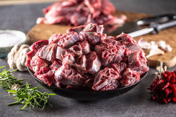 istock Fresh beef shank cuts piled in a bowl on a dark surface with herbs and spices around. 1418941457