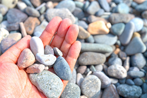 Selective focus of  pebble stone in hand  at black sea Batumi Georgia for background and inspiration