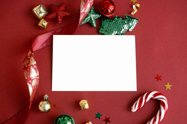 istock Christmas card flat lay. Modern greeting card mock up composition with christmas decorations on red background. Empty postcard template with space for text. Merry Christmas and Happy Holidays! 1418944526