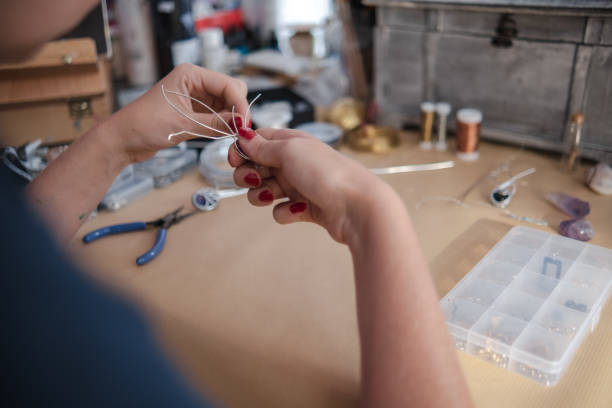 istock Making a DIY necklace from silver wire and crystal 1418953846