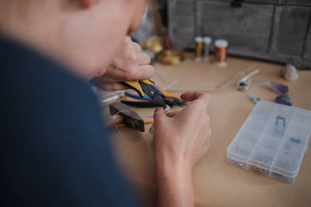 istock Making a DIY necklace from silver wire and crystal 1418955173